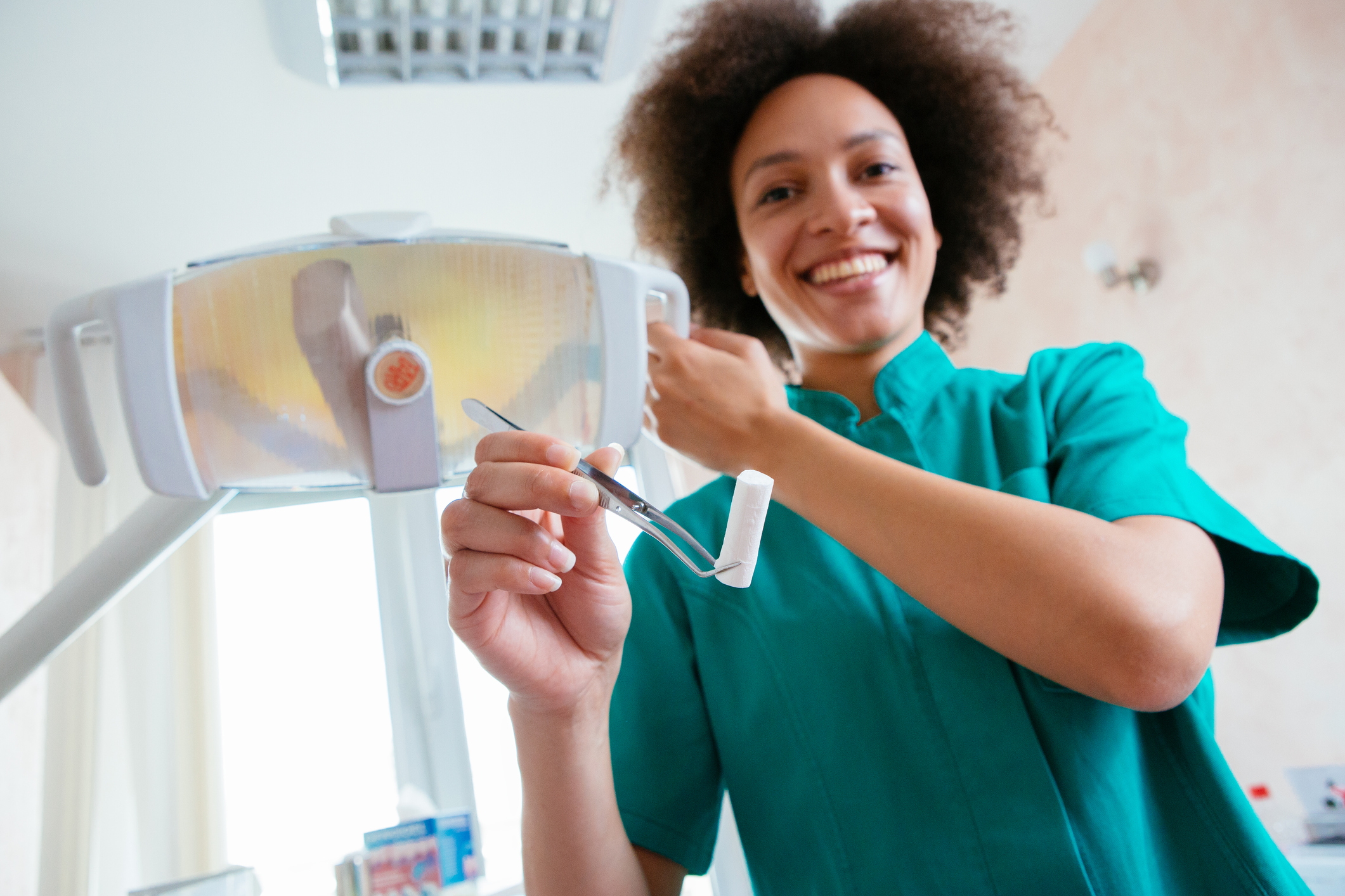 a female dental assistant smiling on a chairside