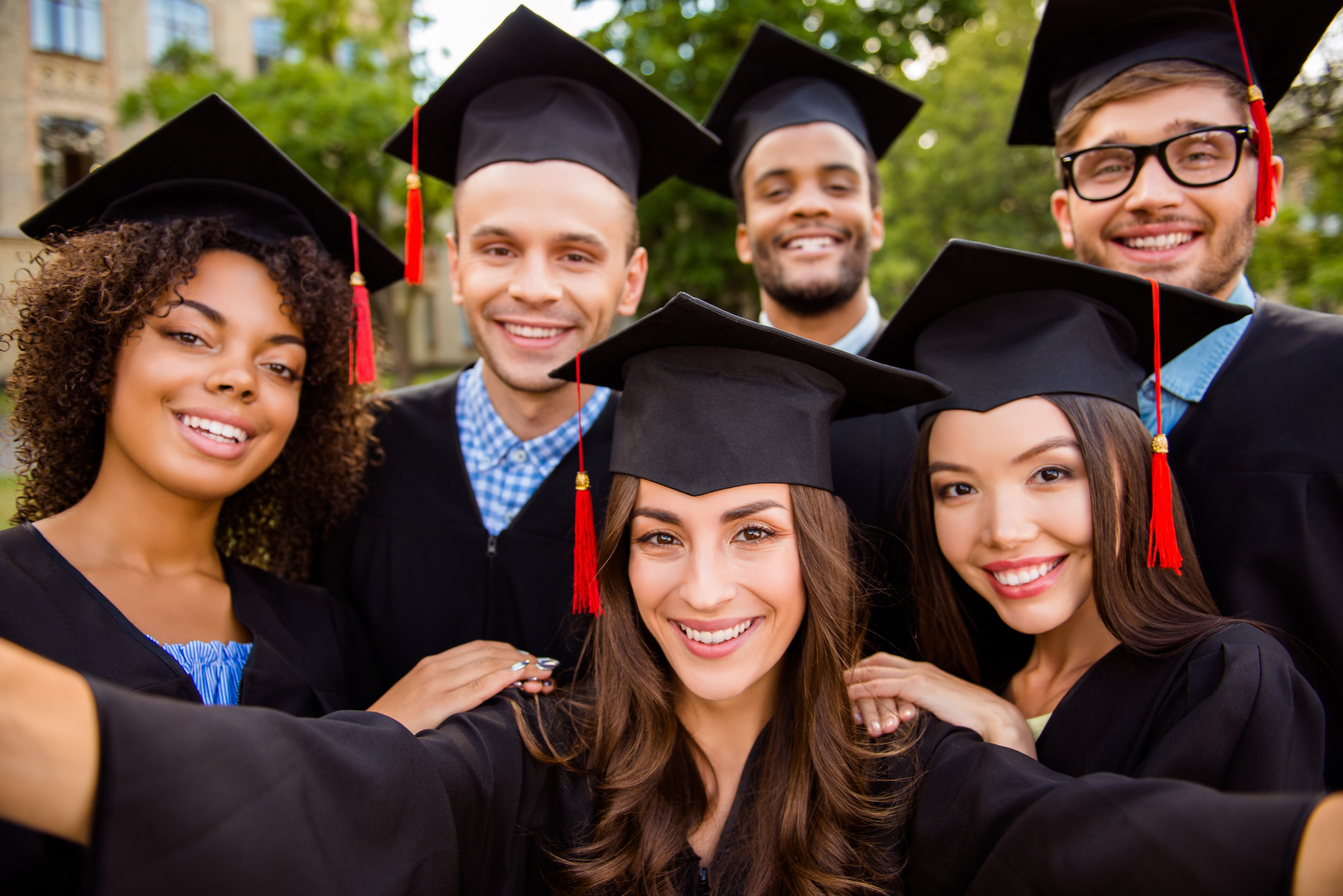 a group of graduates wearing gowns and hats