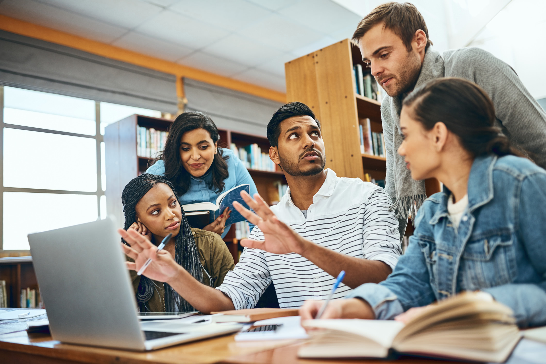 5 students learning at a vocational college with a tutor