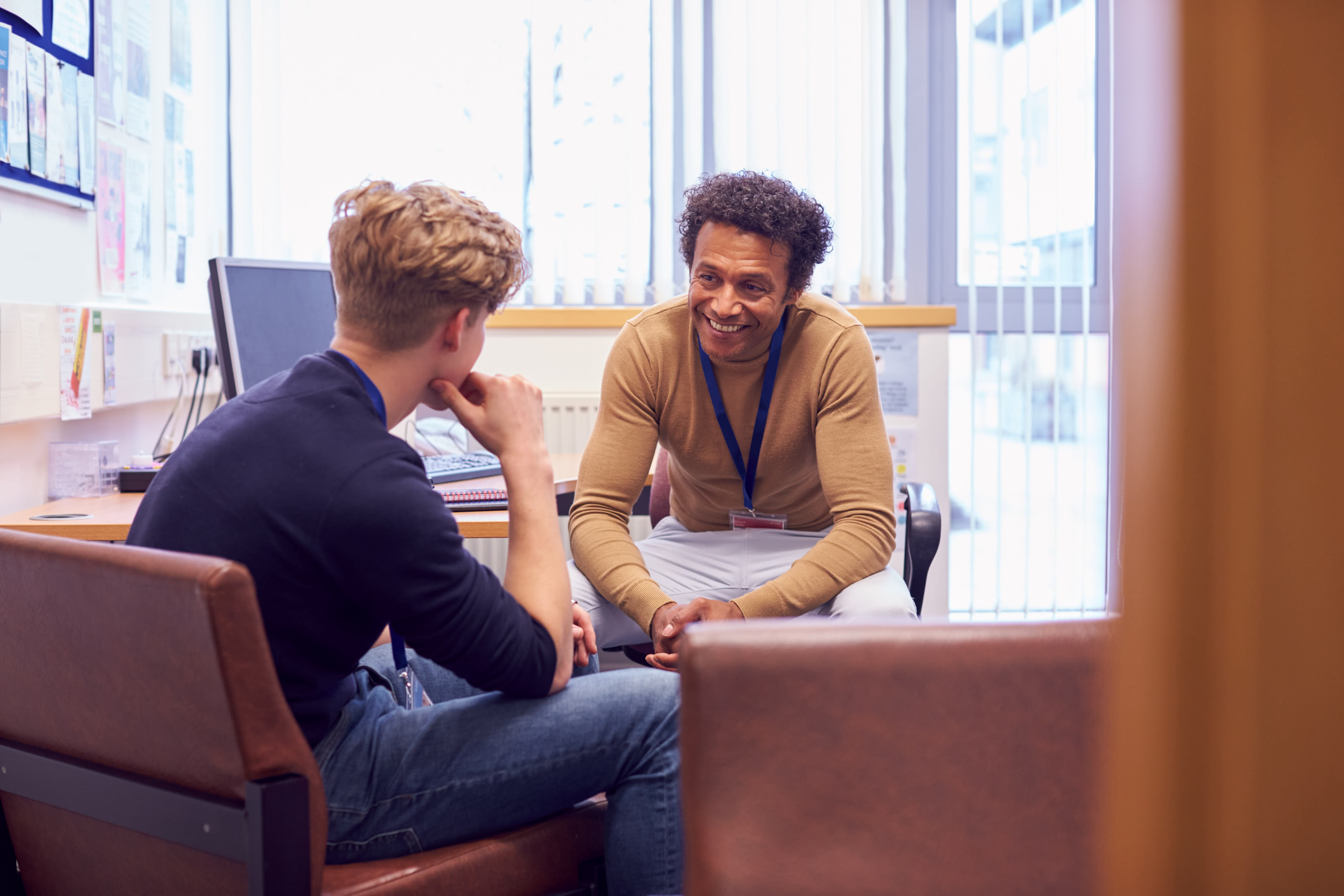 Male student discussing college to a male advisor