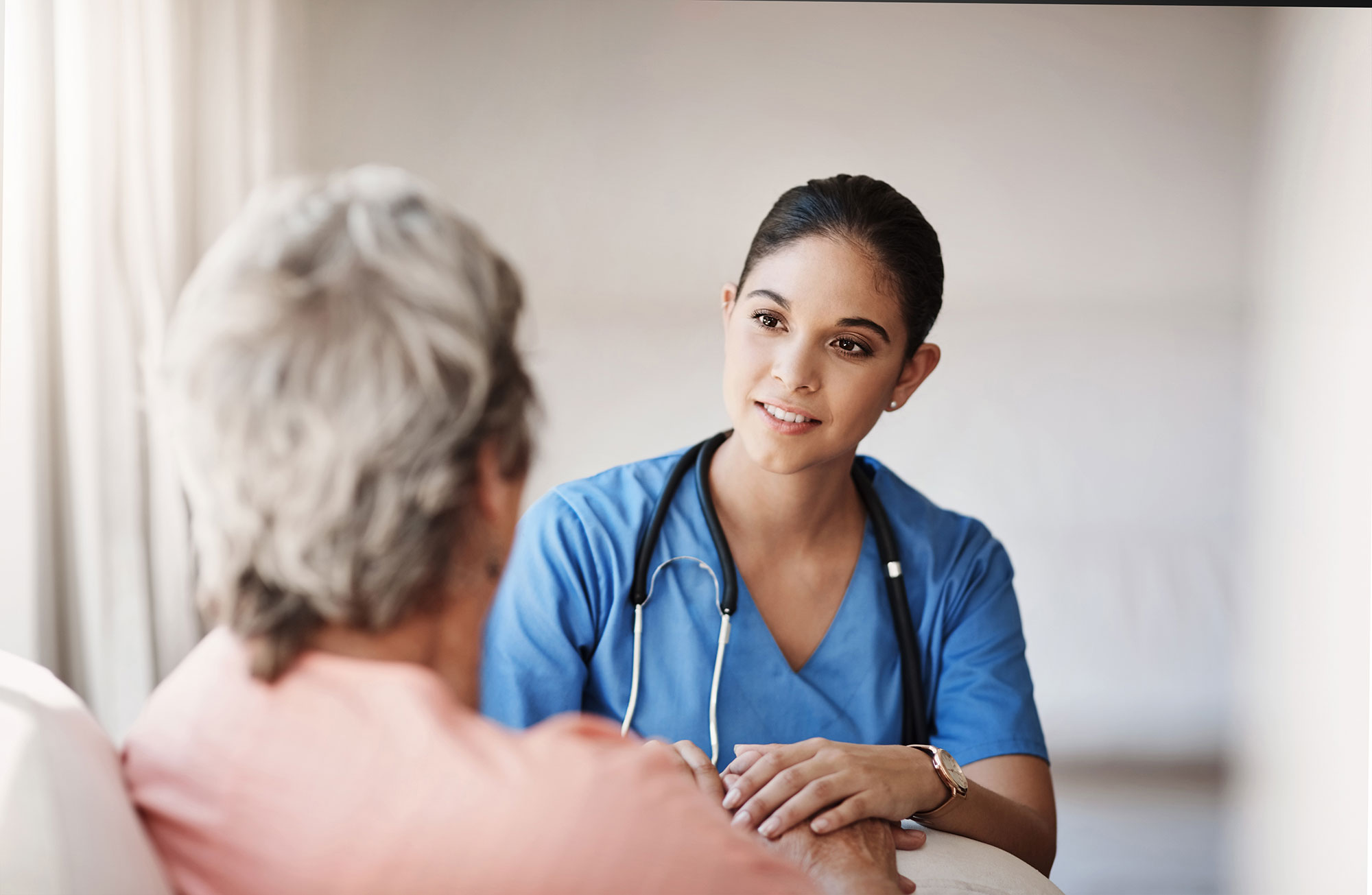 a medical assistant helping an elderly patient