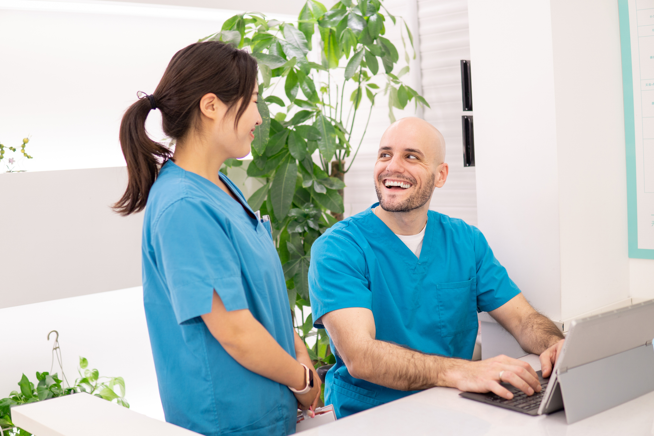Female Medical assistant talking to a male medical office assistant