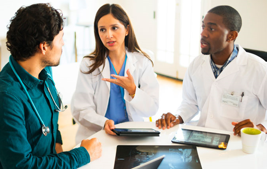 3 Medical Assistants Talking at a table