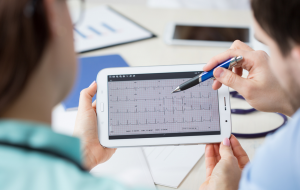 Doctors Looking at Mobile EKG