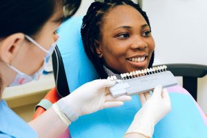 Smiling lady visiting dentist in modern clinic